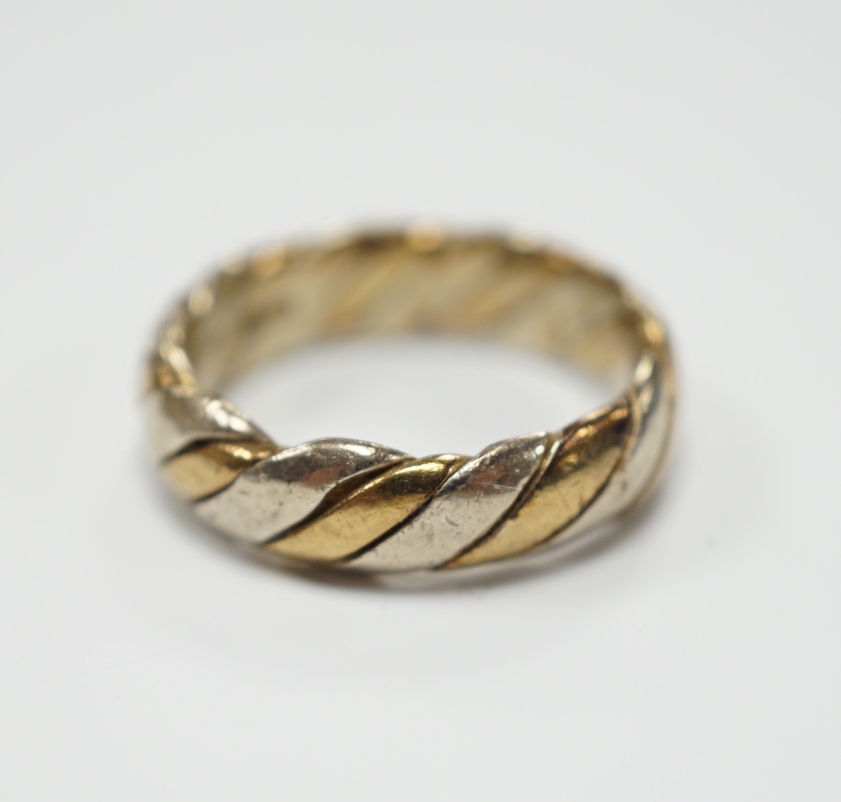 A two colour 9ct gold band size N, 6.3 grams.